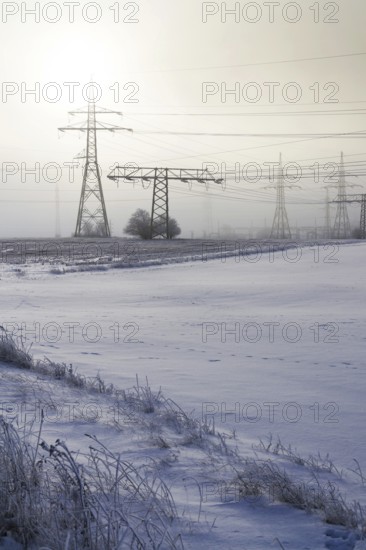 Electricity pylons from distribution power station in foggy winter freeze Prague Czech republic