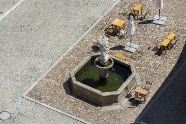 Aerial view of the café tables around the fountain on the square, sunny summer day Slavonice Czech republic