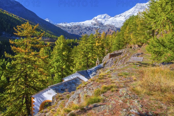 Chapel zur Hohe Stiege on the historic Kapellenweg with Allalin 4027m and Alphubel 4206m in autumn, Saas-Fee, Saasertal, Valais, Switzerland