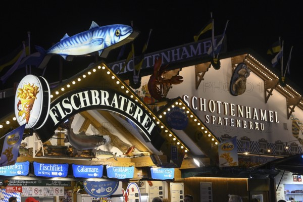 Fish bar and spade party tent at Oktoberfest, Schottenhamel, night view, Munich, Bavaria, Germany