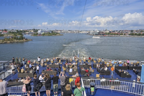 Passengers at the stern, Viking Line XPRS ferry leaves port, Helsinki, Finland