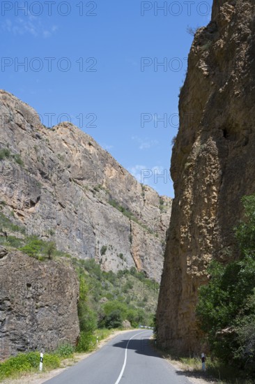 Asphalt road between high rock walls under clear sky, Amaghu Gorge from Noravank Monastery, Noravank, Vayots Dzor Province, Vayots Dzor, Armenia, Caucasus