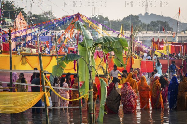 Hindu devotees gather on the banks of the Brahmaputra River to offer prayers to the Sun God on the occasion of Chhath Puja, in Guwahati, India on 27 October 2025