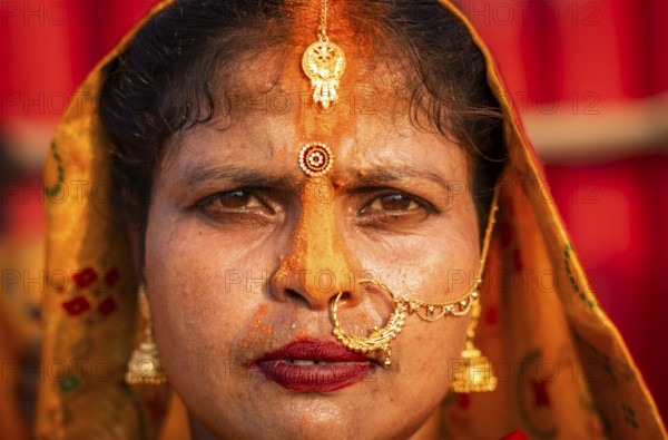 A Hindu devotee offer prayers to the Sun God on the bank of Brahmaputra river on the occasion of Chhath Puja, in Guwahati, India on 27 October 2025
