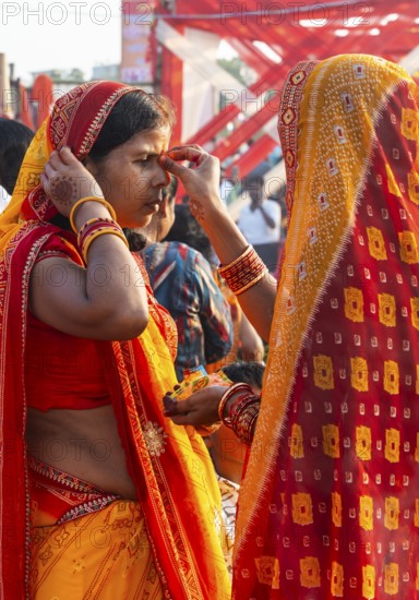 Hindu devotees gather on the banks of the Brahmaputra River to offer prayers to the Sun God on the occasion of Chhath Puja, in Guwahati, India on 27 October 2025