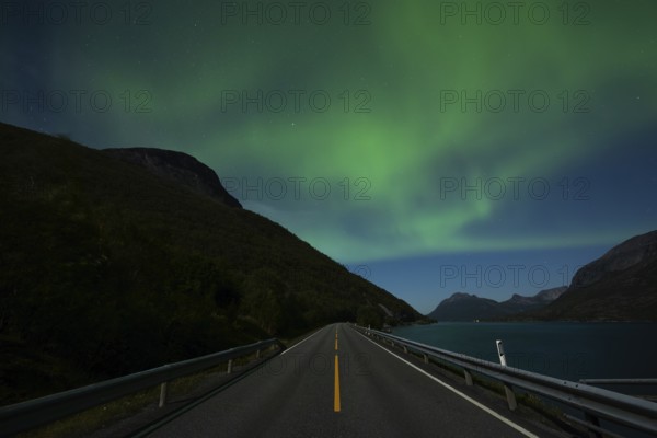 Tysfjord near Stetind Mountain in northern Norway under auroras and full moon