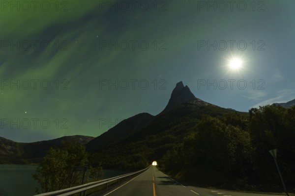 Magical Stetind mountain in northern Norway under auroras and full moon