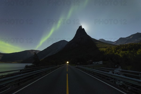 National mountain of Norway, Stetind in the Nordland under auroras and a full moon behind the summit
