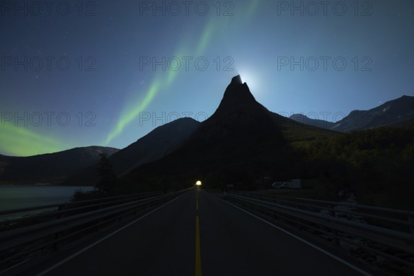 National mountain of Norway, Stetind in the Nordland under auroras and a full moon. On the road towards the tunnel
