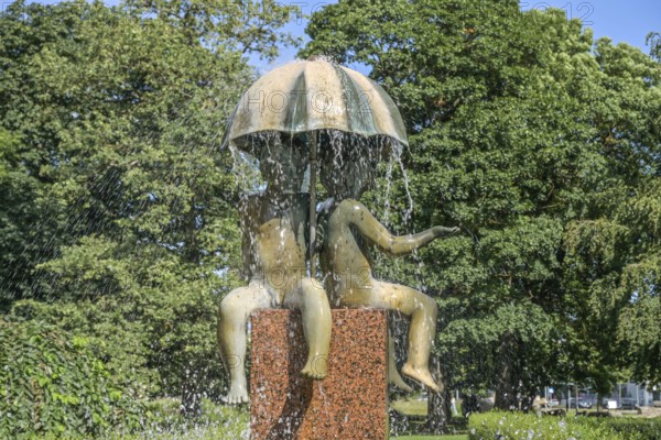 Fountain, children under an umbrella, Kanuti Garden, park, Tallinn, Estonia
