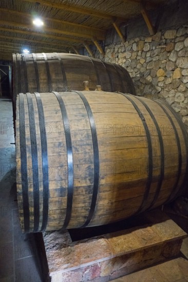 Two large wooden barrels in a cellar with rustic stone walls, Hin Areni Winery, Areni Village, Vayots Dzor Province, Wajoz Dzor, Armenia, Caucasus