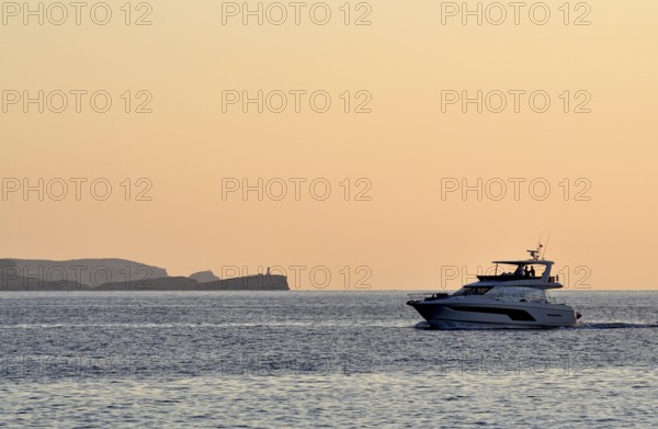 A motor-yacht is cruising off the island of cabrera in the evening, Majorca, balearics, spain