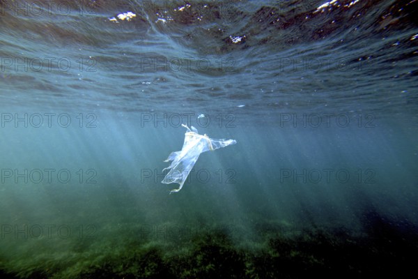 A piece of plastic is floating under the surface of the Mediterranean, Majorca, balearics, spain
