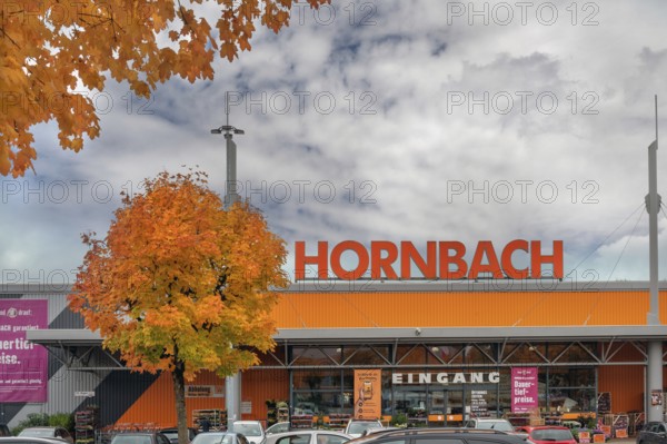 Autumn-colored maples (Acer), and entrance to Baumarkt-hornbach, Kempten, Swabia, Bavaria, Germany