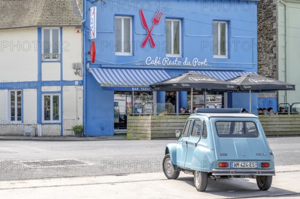 Parked sky blue Citroen 2CV with roll top in front of Café Resto du Port Le Surcouf, a popular simple restaurant in the Port du Legue industrial port, Saint-Brieuc, department of Cotes-d'Armor, Brittany region, France