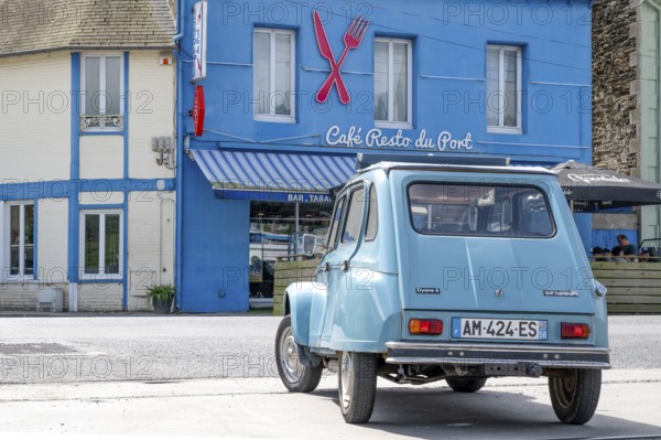 A sky blue Citroën Dyane or 2CV with roll top is parked in front of the bright blue Café Resto du Port (Le Surcouf), a charming and simple restaurant in the Port du Légué of Saint-Brieucim Port du Legue industrial port, Saint-Brieuc, department of Cotes-d'Armor, Brittany region, France