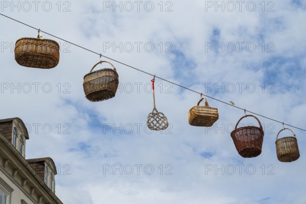 Woven baskets hang over the pedestrian zone in front of the sky, Deutsche Korbstadt, Lichtenfels, Upper Franconia, Bavaria, Germany