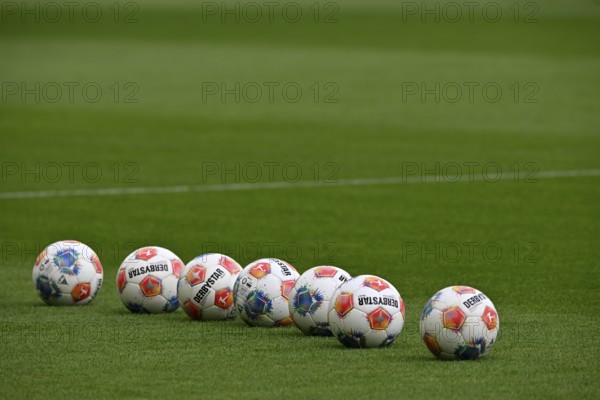 Adidas Derbystar game balls lie in a row on the lawn, PreZero Arena, Sinsheim, Baden-Württemberg, Germany