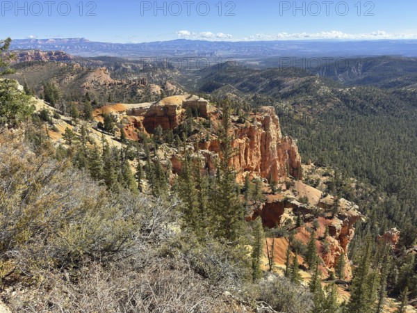 Expansive view of rocky desert landscape with forests and impressive orange sandstone rock formations, Bryce Canyon National Park is located in southwestern Utah in the United States, Majestic rock formations over a dense forest with a wide mountain panorama, Tropic, Utah, USA