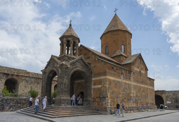 Historic church building with dome, people on a wide path in front of it, Khor Virap monastery, deep dungeon, Ararat province, Armenia