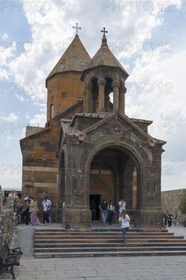Church building with decorative entrance and dome, people enter the historic building, Khor Virap Monastery, Deep Dungeon, Ararat Province, Armenia