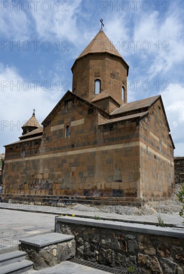 Historic stone church building with distinctive towers and a dome against a blue sky, Khor Virap monastery, Chor Virap, deep dungeon, Ararat province, Armenia