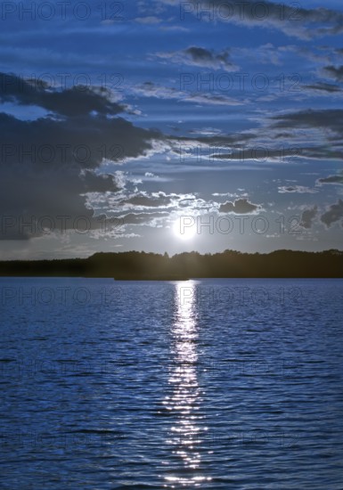 Atmospheric moonrise over Lake Gudelack, Lindow (Mark), Stechlin-Ruppiner Land nature park Park, Brandenburg, Germany