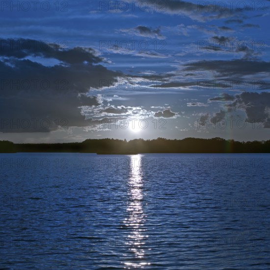 Atmospheric moonrise over Lake Gudelack, Lindow (Mark), Stechlin-Ruppiner Land nature park Park, Brandenburg, Germany