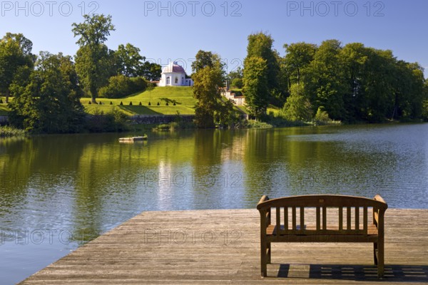 Footbridge with bench to Huwenowsee at Meseberg Castle Park, guest house and conference venue of the Federal Government, Gransee, Brandenburg, Germany