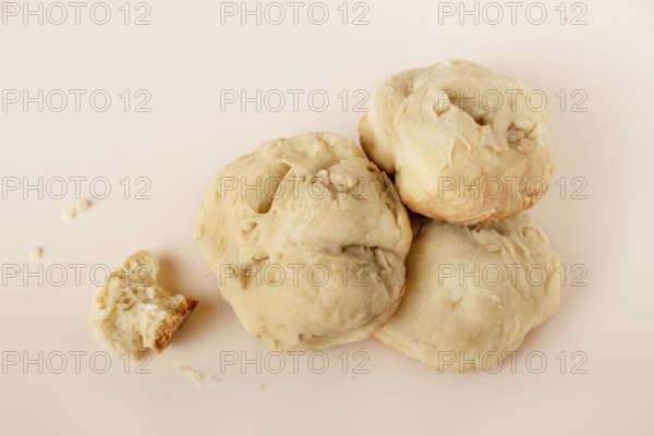 A stack of homemade buns on a beige background