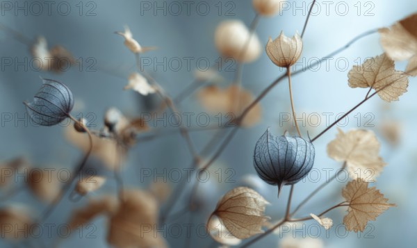 A close up of a branch with flowers and leaves. The flowers are blue and the leaves are brown. The image has a calming and peaceful mood. AI generated