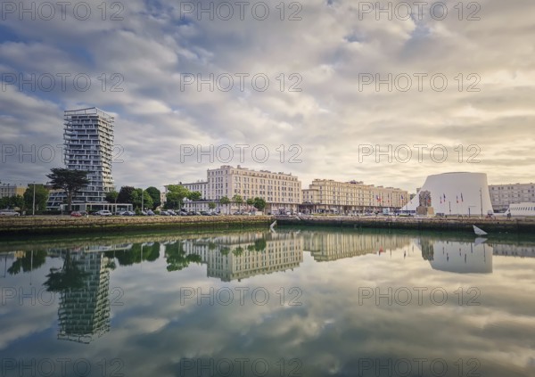 Beautiful waterfront scene in Le Havre, France at sunset. Buildings are perfectly reflected in the still water, Le Havre, Normandy, France