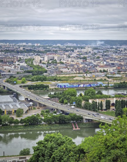 Rouen, France, May 29, 2025: Elevated view of the french city of Rouen, from the hill Sainte-Catherine, under a cloudy sky, with Seine river in the foreground, Rouen, France
