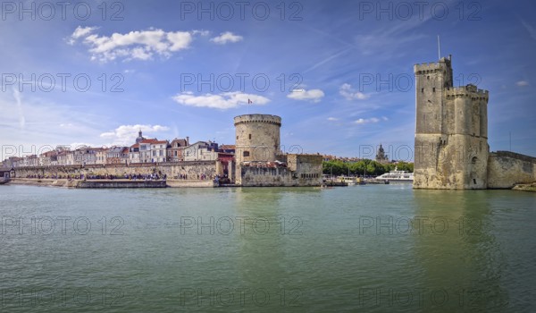 Panoramic view of the iconic entrance to the Vieux Port of La Rochelle, France. Panorama of all three medieval towers guarding the marina, the Tour Saint-Nicolas near the chain and the lantern towers, La Rochelle, France