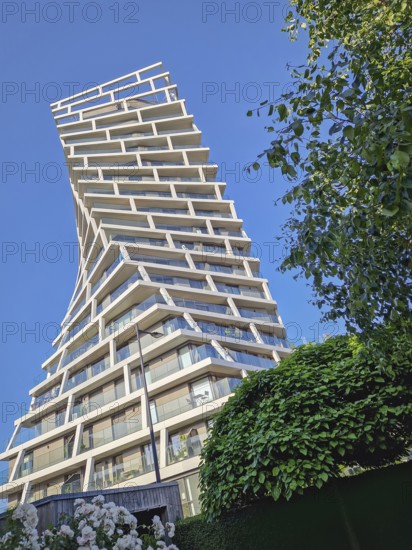 Tour Alta in Le Havre, France, a striking residential skyscraper with modern architecture in unique twisting, helical form. Geometric complexity tower, contemporary urban design, Le Havre, France