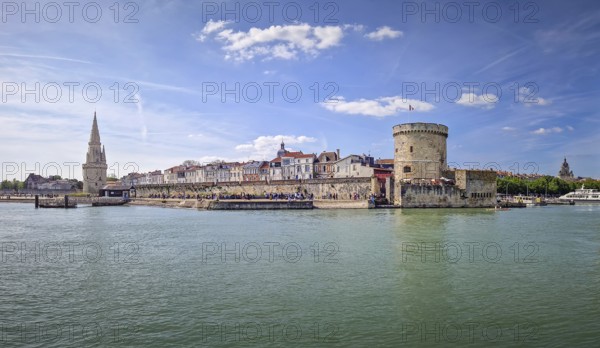 The entrance to the Vieux Port of La Rochelle, France. Panoramic view of all the medieval landmarks guarding the marina, the chain and the lantern towers, La Rochelle, France