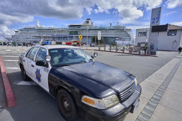 Police vehicle in front of a cruise ship near Fishermans Wharf in San Francisco, California, USA