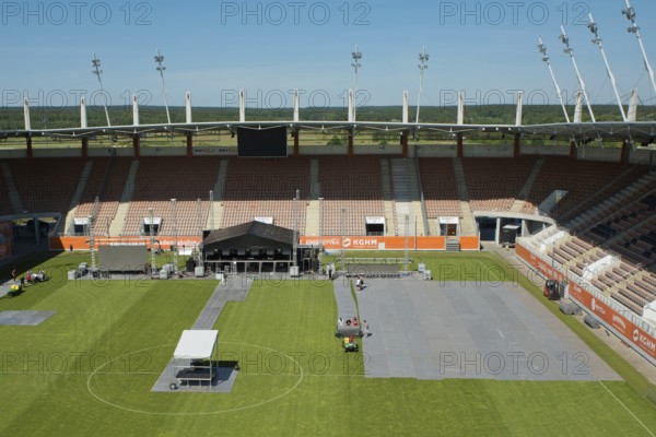 LUBIN, POLAND - JUNE 09, 2017: Workers laying protection on the grass at the stadium before Cuprum Hits Festival