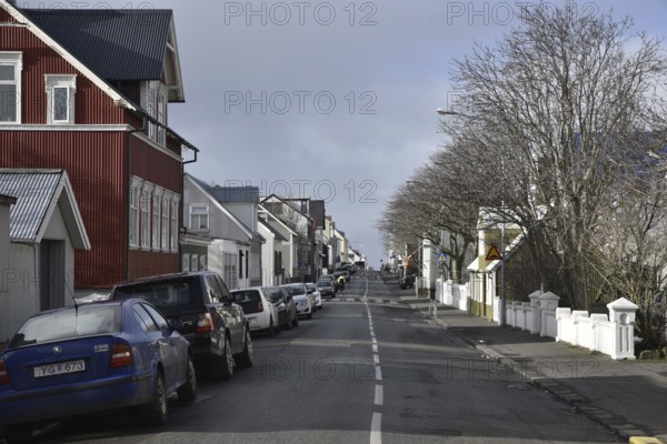 REYKJAVIK, ICELAND - MARCH 12, 2017: Street in Reykjavik with cars and houses