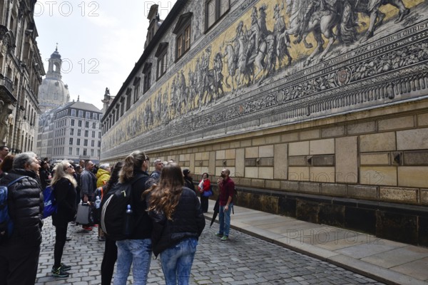 Dresden, Gerrmany- May 6, 2017: Tourist looking at the panel Procession of Princes the first of the city's many Renaissance buildings. Dresda, Saxony