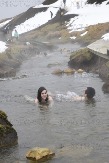 REYKJADALUR, ICELAND MARCH 13, 2017: Swimming in the thermal stream near Reykjavik