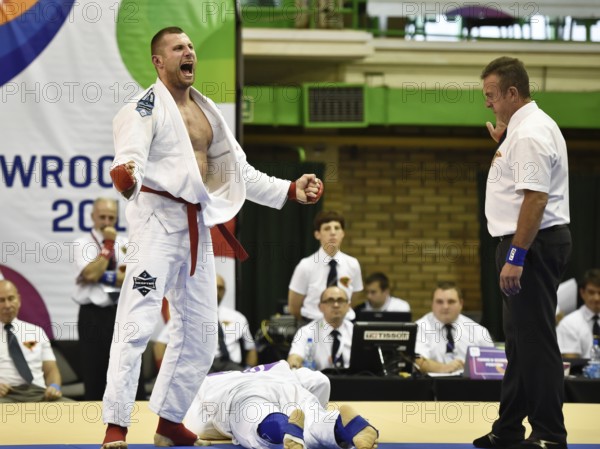 WROCLAW, POLAND - JULY 29, 2017: Ju-Jitsu Fighting tournament during the The World Games 2017. Semifinal fight between Tomasz Szewczak POL (red) - Benjamin Lah SLO (blue). Tomasz Szewczak joy after the fight