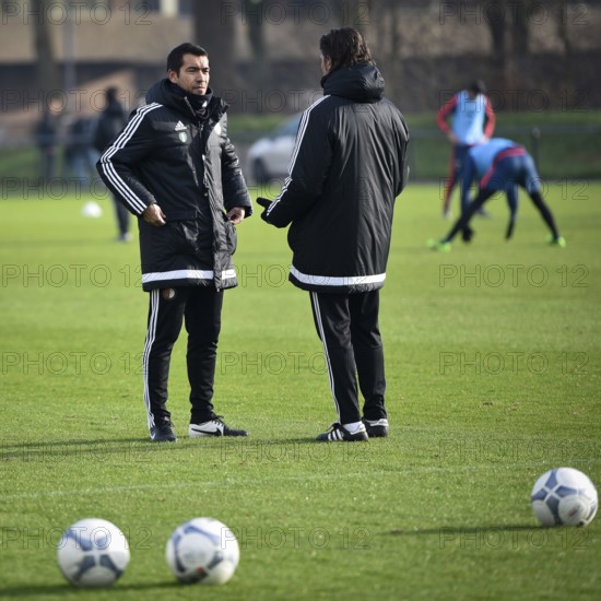 ROTTERDAM, NETHERLANDS - JANUARY 20, 2016: Coach of Feyenoord Rotterdam Giovanni van Bronckhorst (L) talks with the assistant during the team training