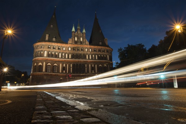 LUBECK, GERMANY - AUGUST 3, 2016: Holstentor Gate during twilight. Lubeck is the 2nd largest city in Schleswig-Holstein region. Its old town is on a UNESCO World Heritage Site