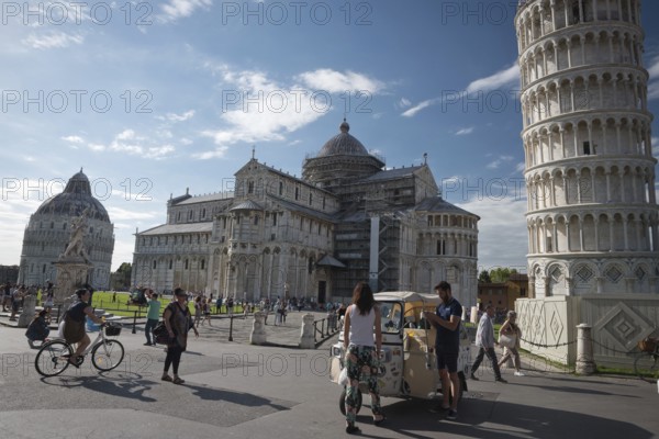 PISA, ITALY - JUNE 15, 2016: Pedestrians near the Pisa Leaning tower, in Square of Miracles (Piazza dei Miracoli)