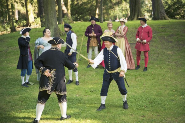 GDANSK, POLAND - August 15, 2017: Two men are fighting by the swords, during historical staging in the Oliwa Park