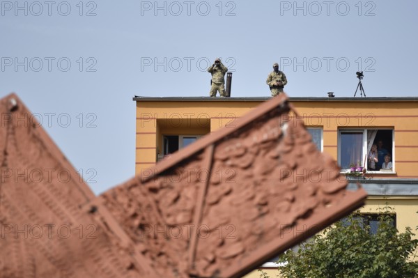 LUBIN, POLAND - AUGUST 31, 2017: Celebrations of the 35th anniversary of the Lubin Crime and the 37th anniversary of the founding Solidarnosc. Soldiers with binoculars on the top of the building