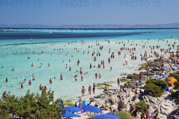 STINTINO, ITALY - AUGUST 21, 2017 - Unidentified people in the sun on the famous La Pelosa Beach on island Sardinia
