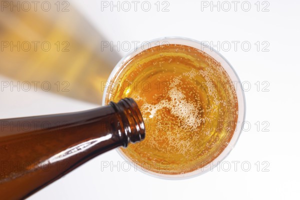 Beer pouring from a bottle into a glass