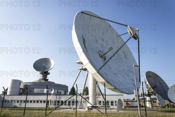 Barbed wire fence around satellite links center with telecommunication tower equipped with radar antennas, cybercrime and cybersecurity concept Prague, Czech republic